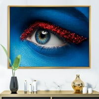 אמנות עיצוב 'עין אישה עם צבע כחול על פנים וכדורים אדומים' הדפס אמנות קיר בד ממוסגר מודרני